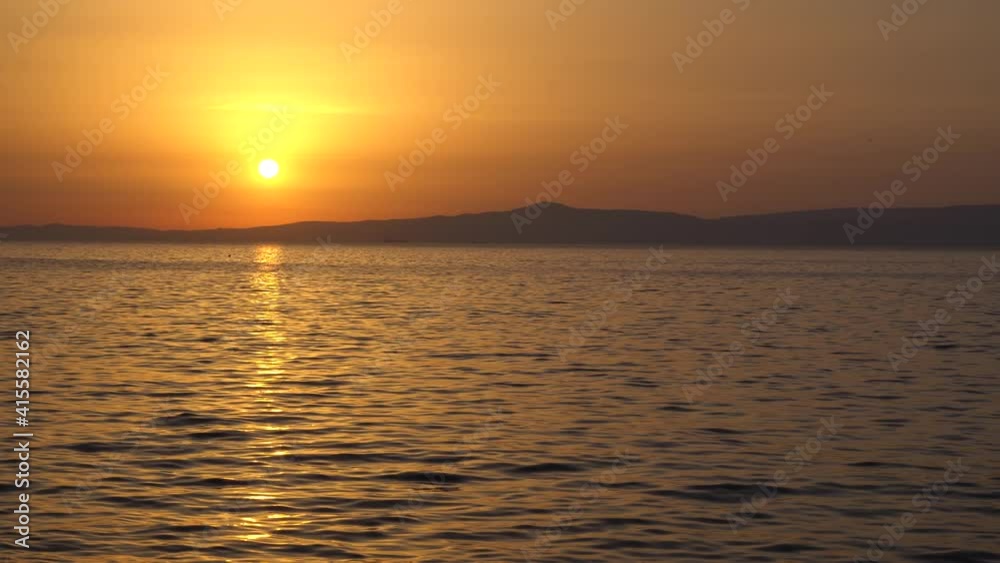 Summer concept: Relaxing sea view of a colorful and dramatic sunset or romantic sunrise reflecting over the sea with focus on water. Tranquility and peace. Meditation. Natural sky and sea background Summer concept: Relaxing sea view of a colorful and dramatic sunset or romantic sunrise reflecting over the sea with focus on water. Tranquility and peace. Meditation. Natural sky and sea background