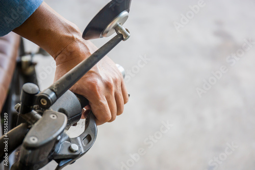 Close up of man's hand turned off the clutch on a motorcycle, hand of a biker holding a motorbike or motorcycle brake.