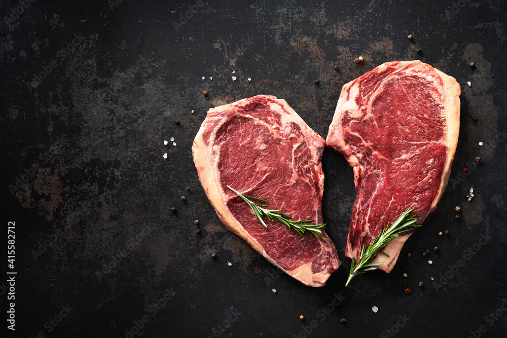 Heart shape raw dry aged beef rib steaks (cote de boeuf) Stock Photo