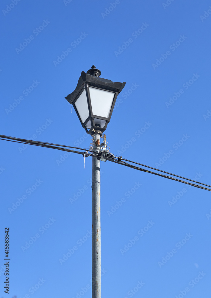 camp lantern stands against a blue sky camp lantern stands against a blue sky