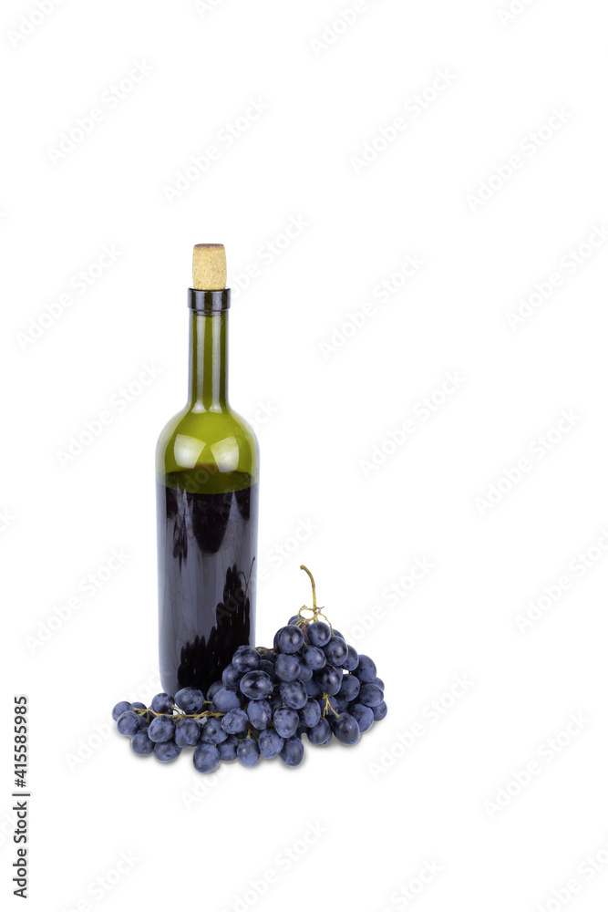 Green bottle with red wine with cork and blue bunch of grapes. Isolated on white background.