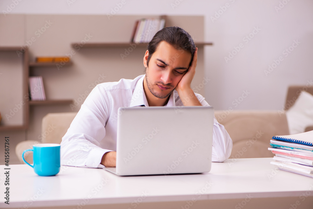 Young male employee working from home during pandemic