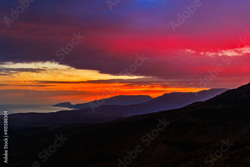 sunset over the hills and the sea in crimea on an autumn evening © Alx_Yago