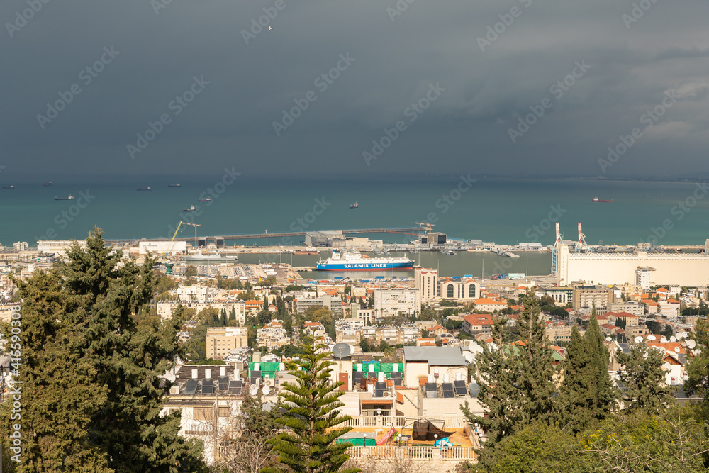 Fototapeta premium View on a rainy day from Mount Carmel to the downtown, the port and the Mediterranean Sea and Haifa city, in Israel.