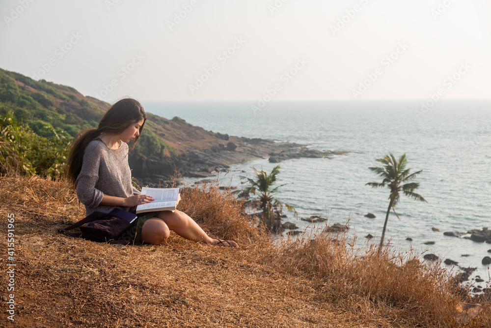 One asian woman and a book with sea view