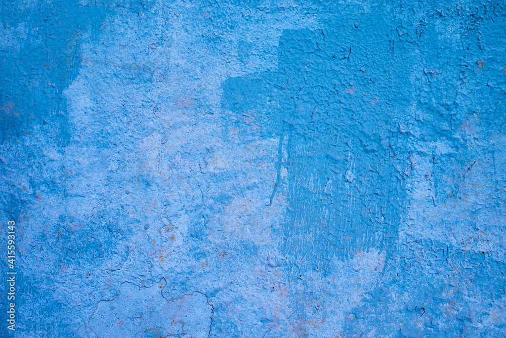 the texture of an old blue painted wall. rough background.