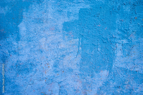 the texture of an old blue painted wall. rough background.