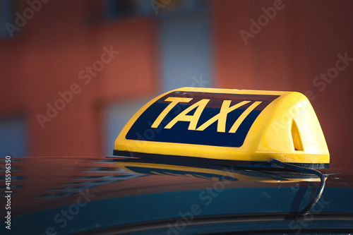 Taxi top sign. Taxi car sign at day time, taxi sign on cab roof while parking on road waiting for passaenger