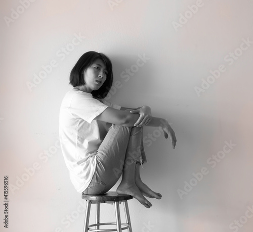 Fotografie Unhappy woman leaning against the wall,with upset and sad feeling,mental