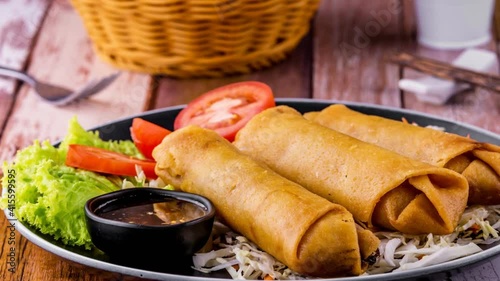 Fried spring rolls on dark wooden background photo