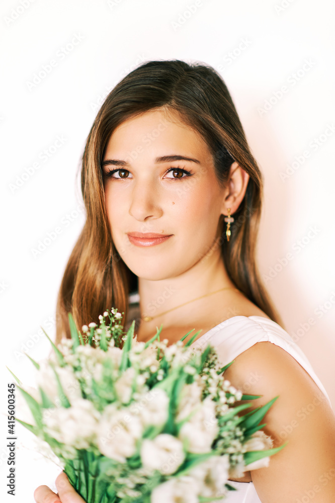 Portrait of young pretty woman holding white tulips Portrait of young pretty woman holding white tulips