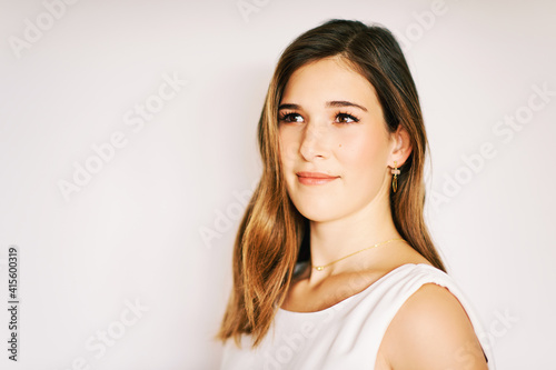 Close up portrait of young pretty woman on white background, brown hair, perfect skin, soft makeup