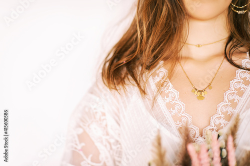 Close up image of beautiful woman wearing stylish earrings and necklace