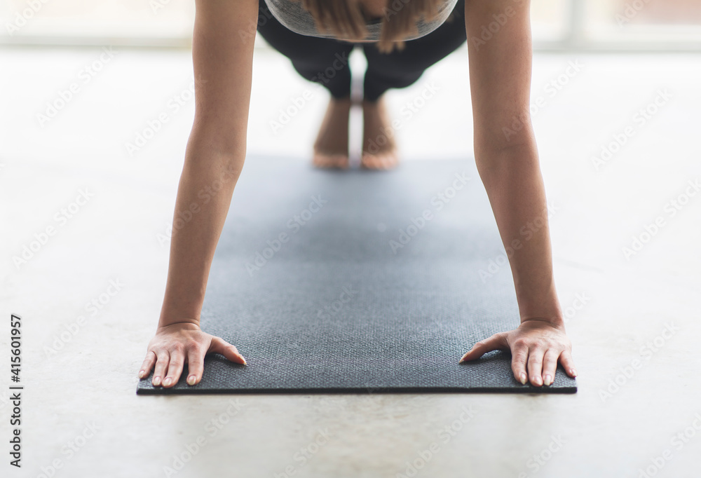 Anonymous woman view over yoga or gym mat during push up move