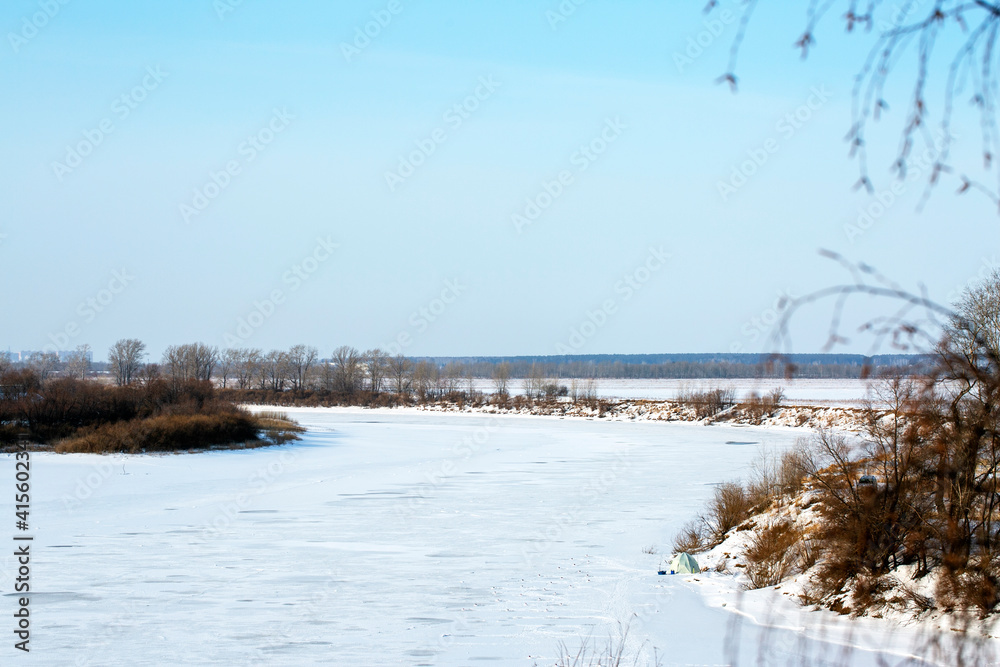 Beautiful calm winter landscape.
A frozen river with trees along the coastline. Snowy coastline of the river. Frosty winter day. Blue tinted.
Beautiful calm winter landscape.
A frozen river with trees along the coastline. Snowy coastline of the river. Frosty winter day. Blue tinted.