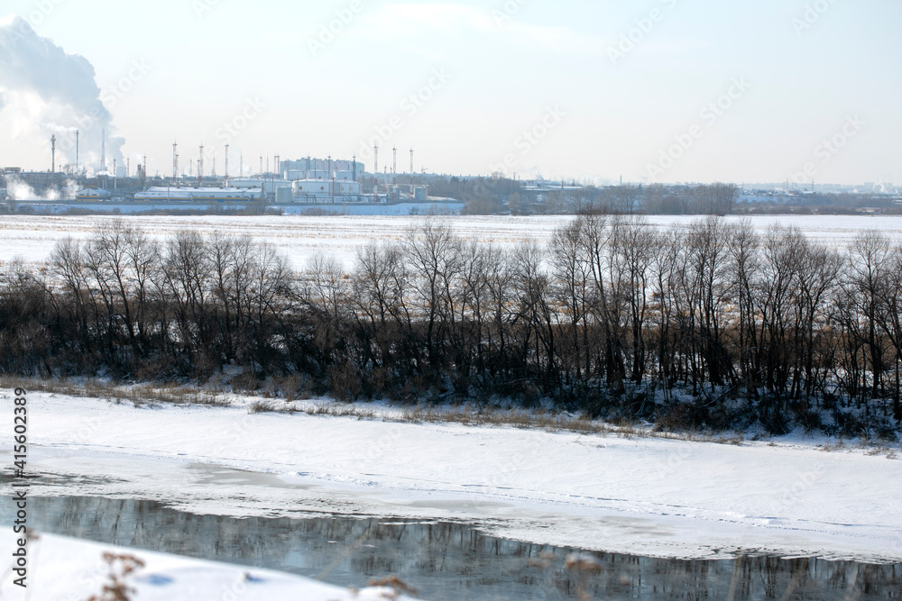 River in the winter. Trees along the edge of the shore. River bank in the snow. Winter landscape