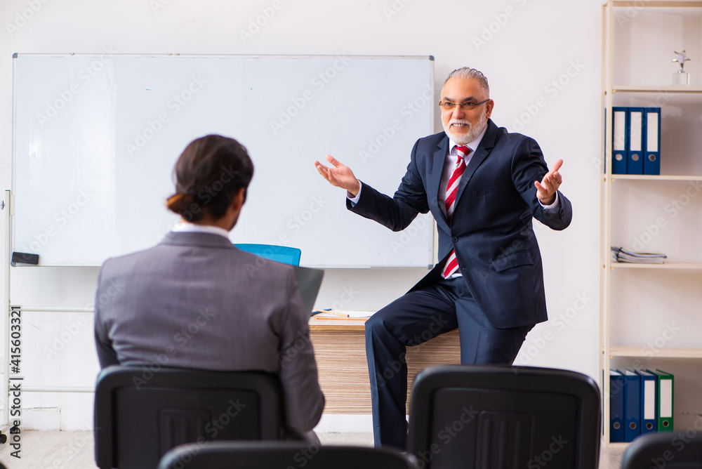 Two businessmen in the classroom in pandemic concept Two businessmen in the classroom in pandemic concept