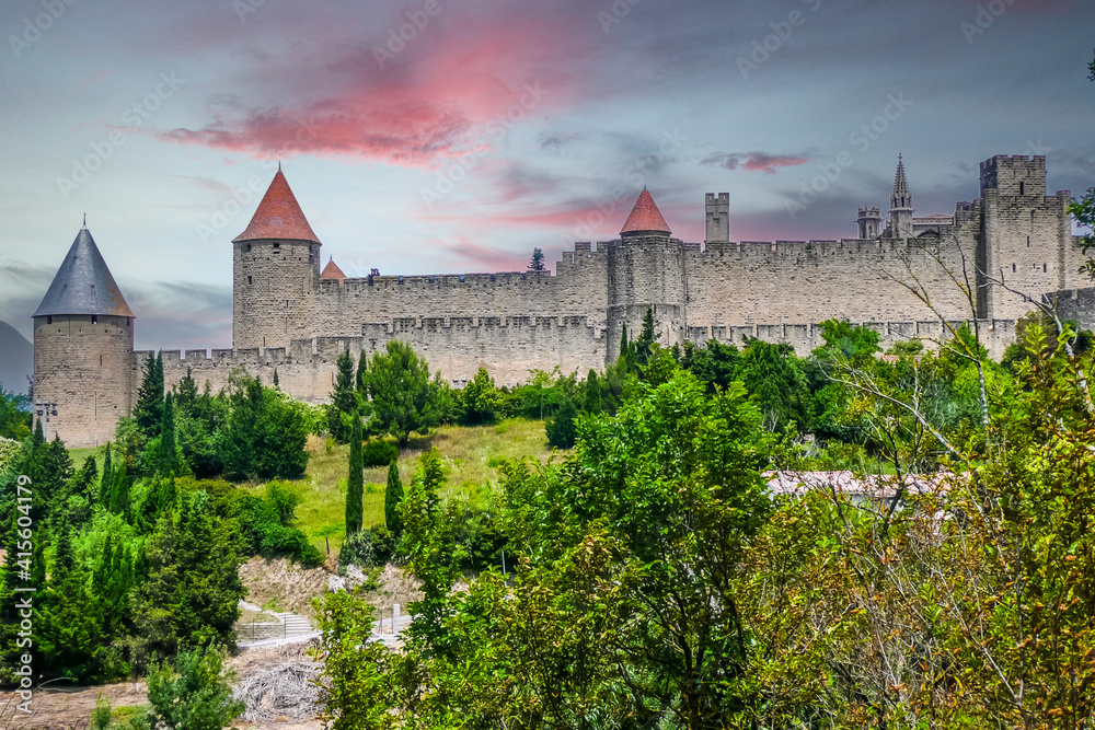 panoramic view of the historic center of Carcassonne surrounded by the walls of an old castle at sunset