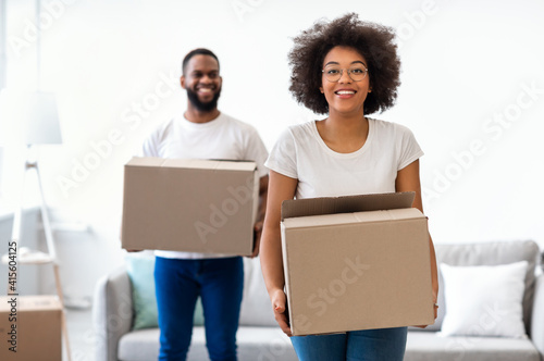 Black Couple Moving Carrying Packed Cardboard Boxes Into New Home