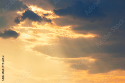 clouds in dramatic evening light. warm yellow nature background