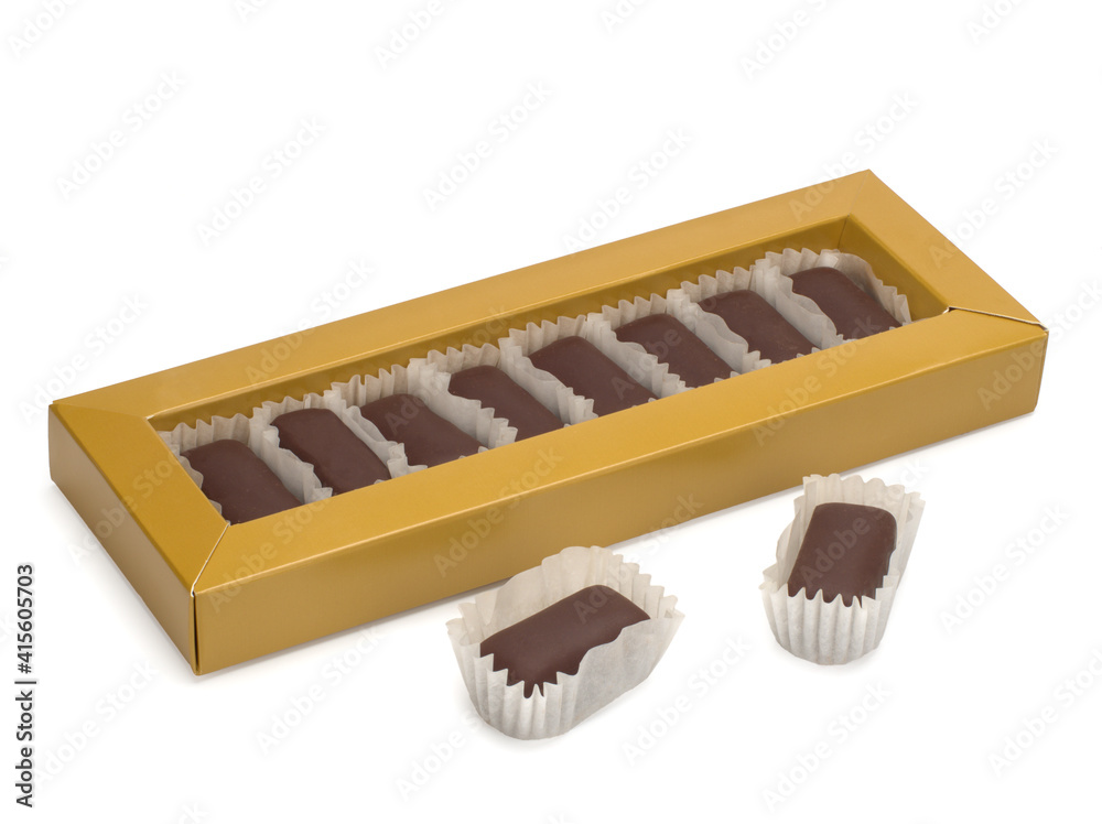 A set of chocolate sweets in a paper box a on white background. A set of chocolate sweets in a paper box a on white background.