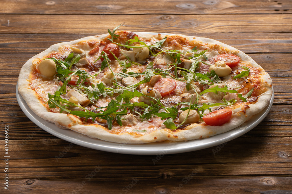 Pizza with bacon, chicken, mushrooms, arugula, tomatoes and mozzarella cheese Pizza with bacon, chicken, mushrooms, arugula, tomatoes and mozzarella cheese