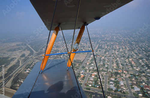 Port Wing of a de Havilland Tigermoth in Flight Over a City photo
