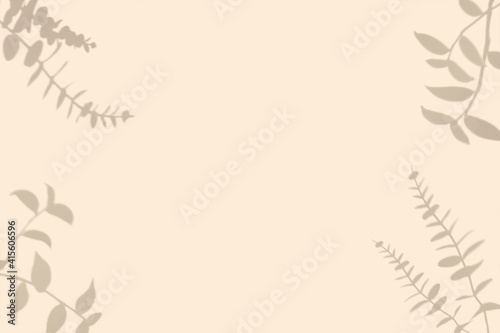 Top view of green tropical leaf shadow on pastel beige  color background.