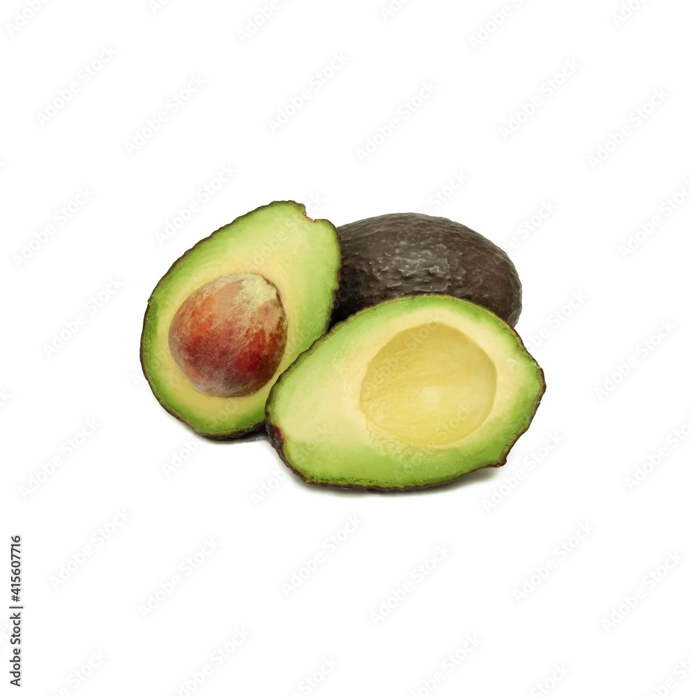 Avocado or alligator pear (Persea americana) whole and halved, isolated on white background.