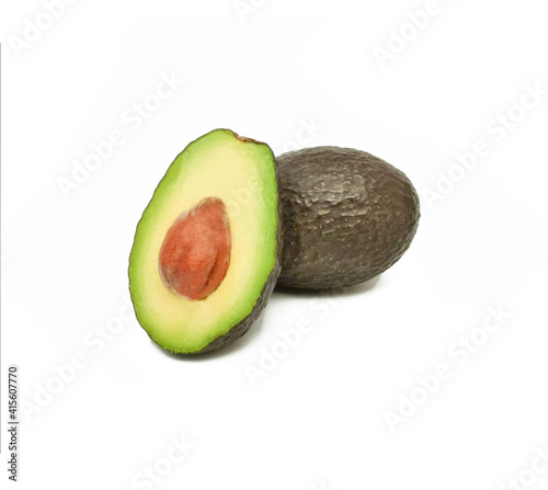 Hass avocado (avocado pear or alligator pear) whole and in half on white background