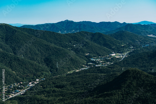 View of the valley with a road and buildings running through in Bukhansan National Park. photo