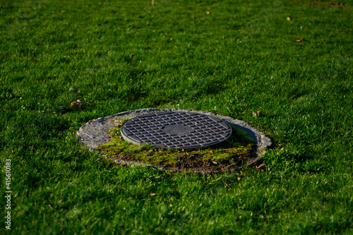Sewer manholes in the city park, drainage system, reservoirs.