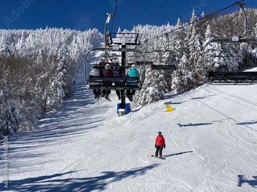 Ski chair lifts at Okemo mountain ski resort at sunny winter day in Vermont USA photo