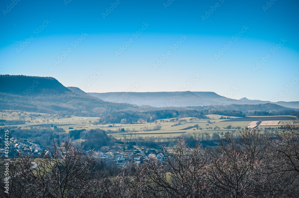 Beautiful aerial view of forests in front of the mountain ridges of the Swabian Alb on a sunny winter day without snow. Beautiful aerial view of forests in front of the mountain ridges of the Swabian Alb on a sunny winter day without snow.