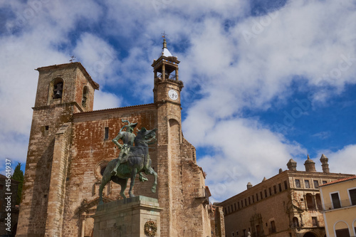 Equestrian statue of Francisco Pizarro in Plaza Mayor de Trujillo (Caceres). Work of the American sculptor Charles Casy Rumsey. In the background the Church of San Martin. photo