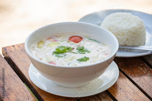 Thai coconut cream soup in bowl, close up