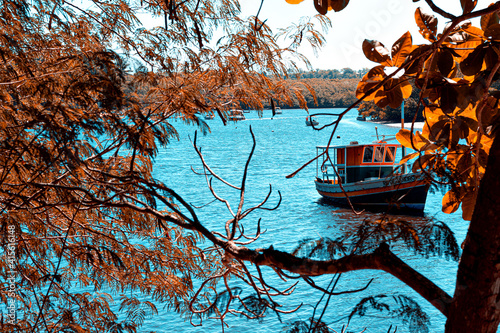 Barco navegando em rio de Caraíva, Bahia, Brasil photo