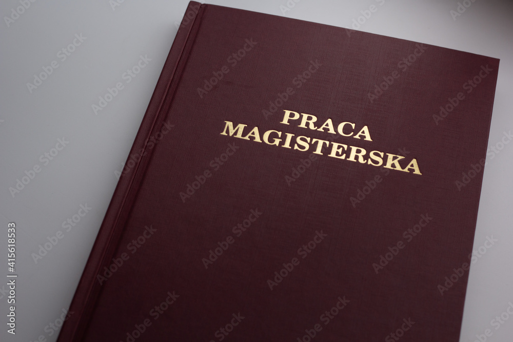 Closeup of Polish Master's Thesis (Praca magisterska) on white background. Closeup of Polish Master's Thesis (Praca magisterska) on white background.