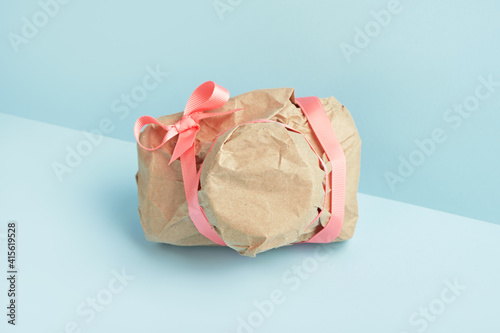 Fotografi Photo camera wrapped in craft paper. Mysterious surprise, gift