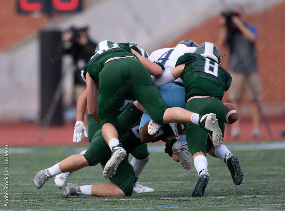 Boy athlete playing in a competitive football game Boy athlete playing in a competitive football game
