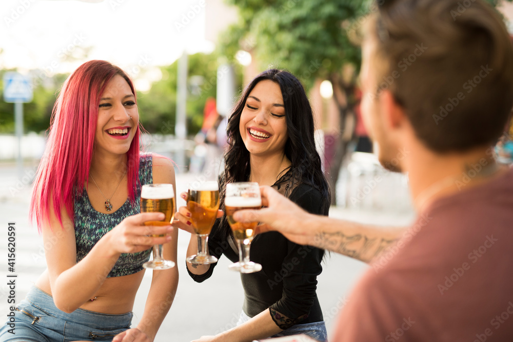 Friends drinking beer having fun in bar terrace with beer Friends drinking beer having fun in bar terrace with beer