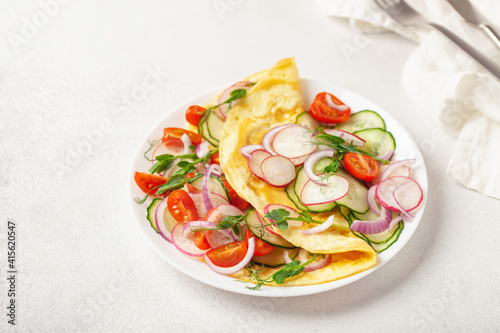 Stuffed vegetable omelette - cucumber, tomato, radish, onions and pea sprouts. Healthy breakfast.