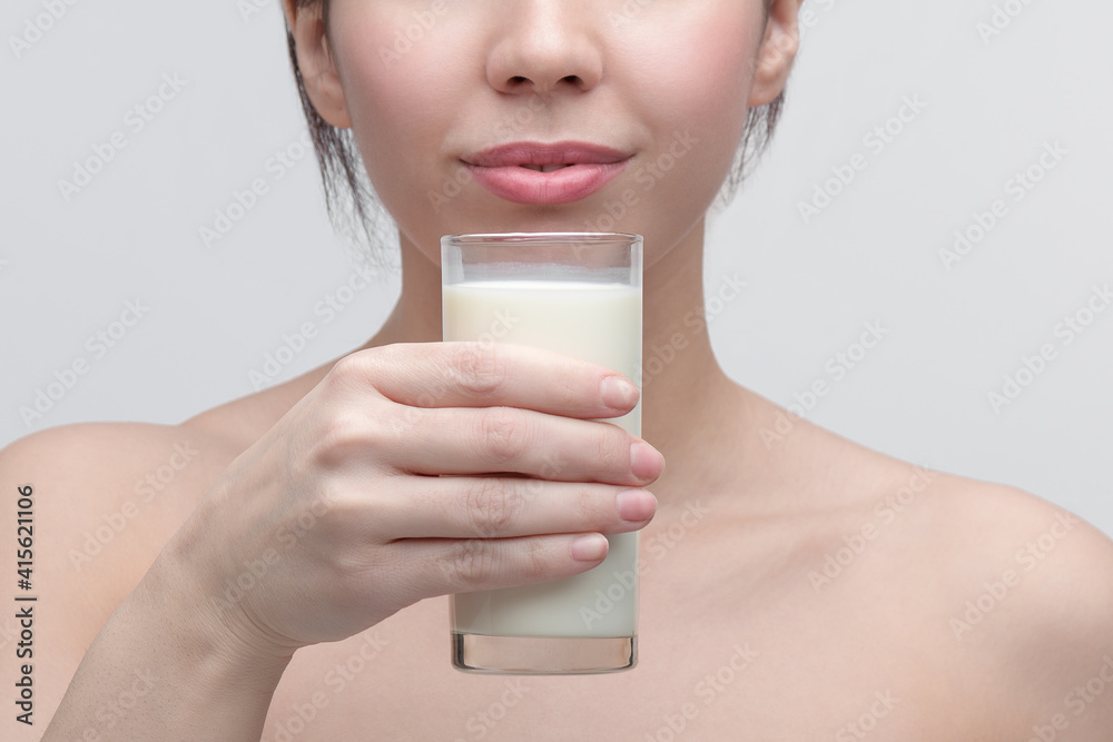 Woman holding glass of milk infront of her face and prepear to drink. closeup . Woman holding glass of milk infront of her face and prepear to drink. closeup .