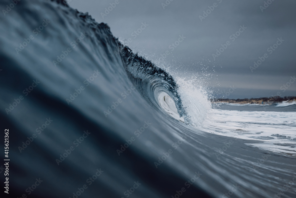 Perfect ocean waves with water cloudy dark sky. - obrazy, fototapety, plakaty 