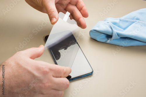 Quadro em tela top view of installation of protective cover film on the smartphone