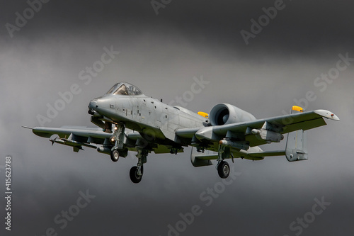 A10 tank buster jet in grey colour scheme landing on a stormy day with dark clouds photo