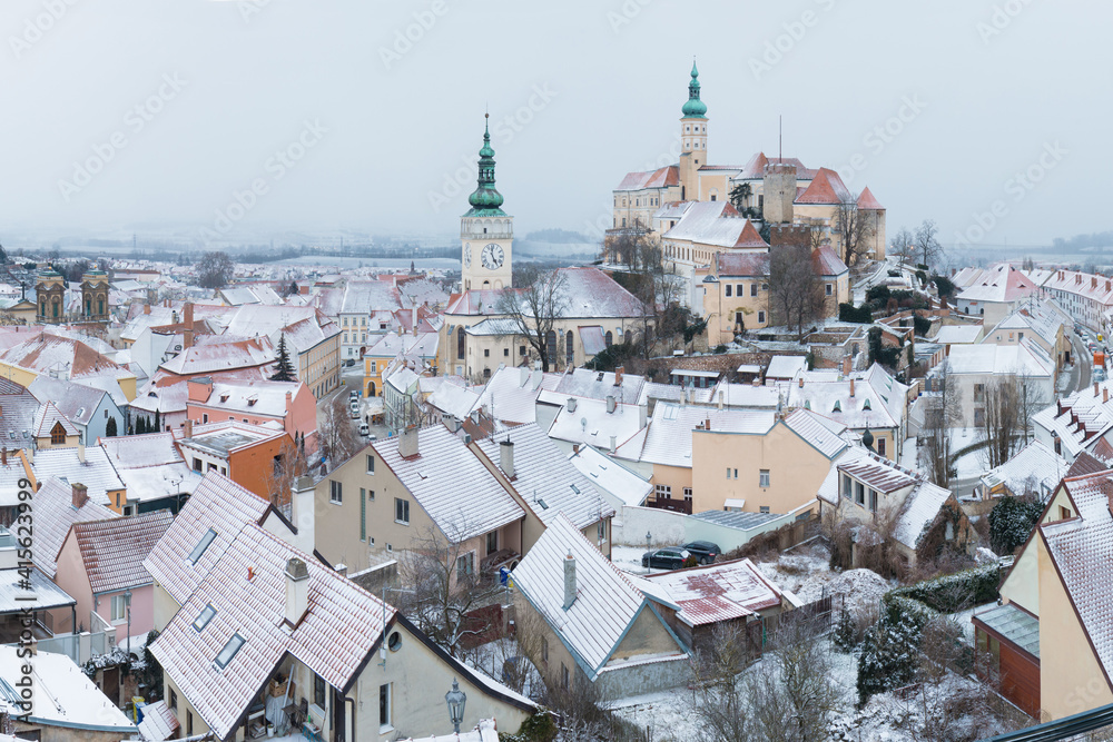 Fototapeta premium Scenic panorama romantic view of beautiful historical landmark Mikulov Castle and historical city centre of Mikulov in South Moravia, Czech Republic. Castle at sunrise near Austria border. Winter time