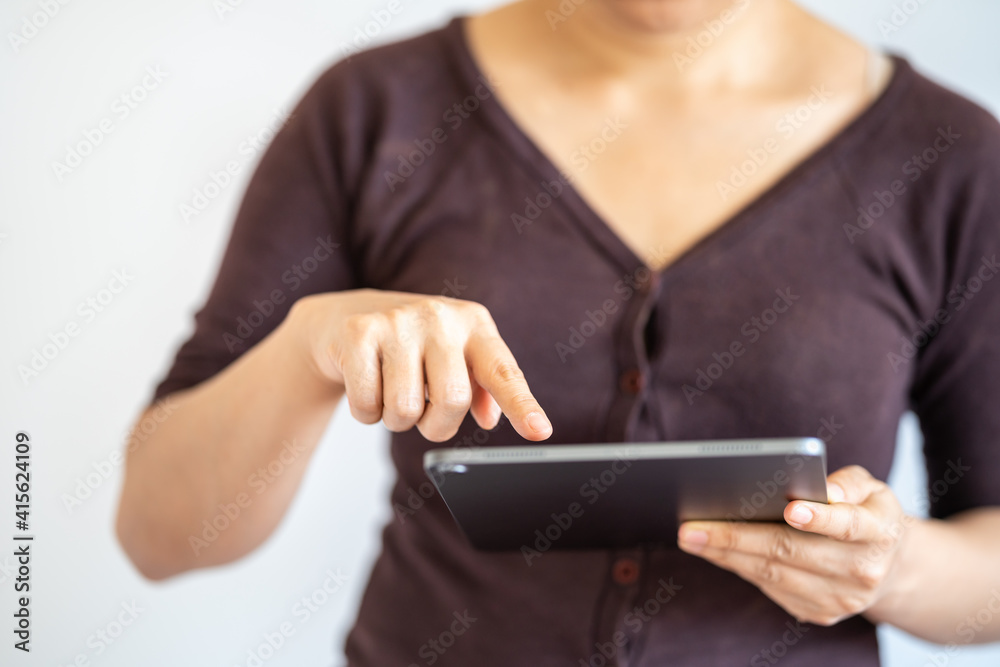 Business and Technology Concept. Closeup of woman hands using and holding tablet on white background.