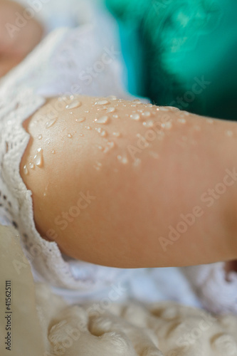 Baptism of a baby, close up of tiny baby feet, sacrament of baptism.