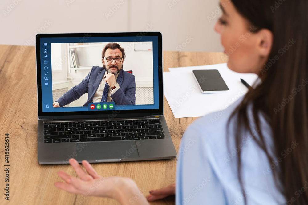 Rear View Of Female Entrepreneur Having Online Conference Business Meeting With Boss Rear View Of Female Entrepreneur Having Online Conference Business Meeting With Boss